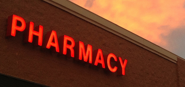 Picture of a lit pharmacy sign during sunset