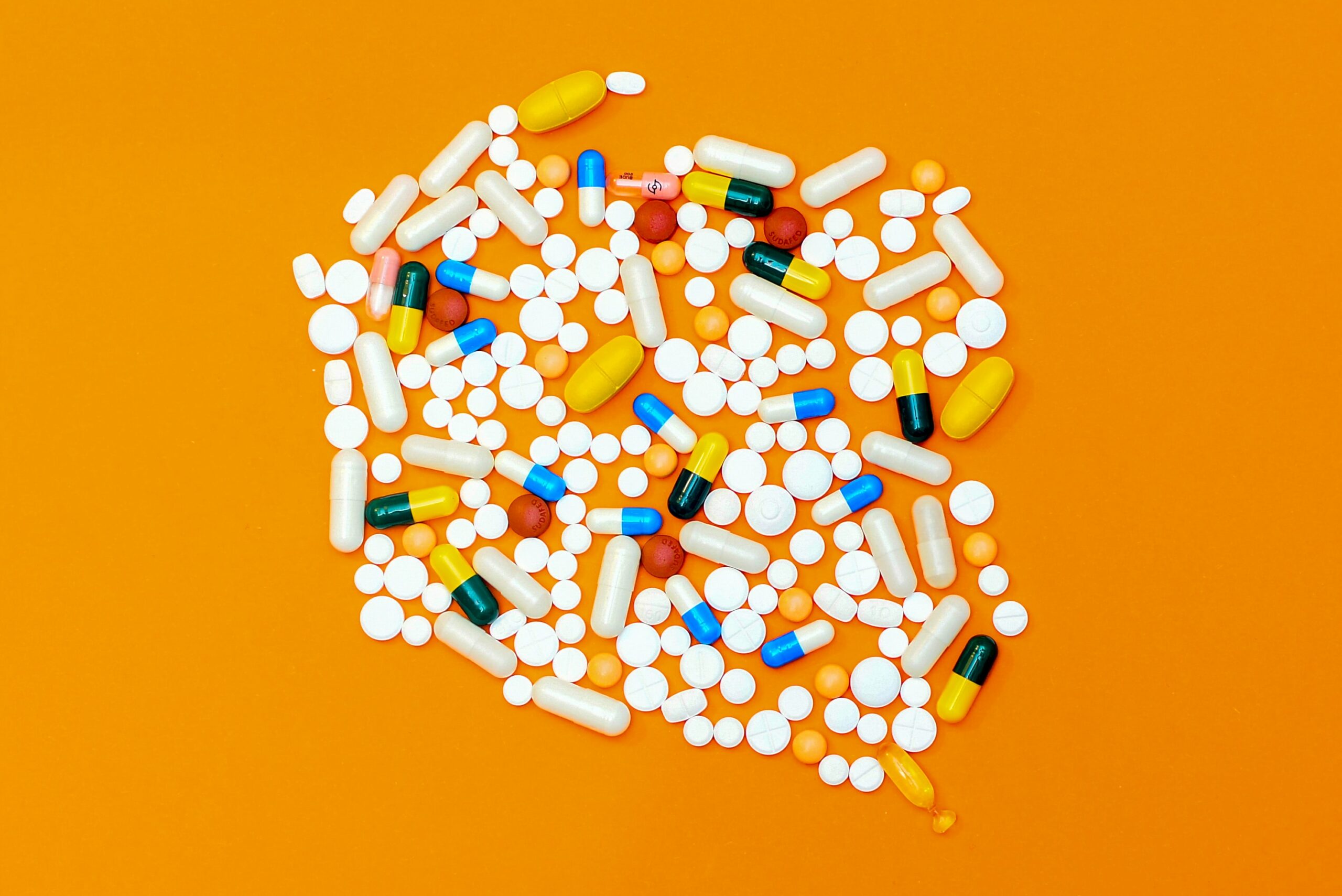 Pills on an orange table
