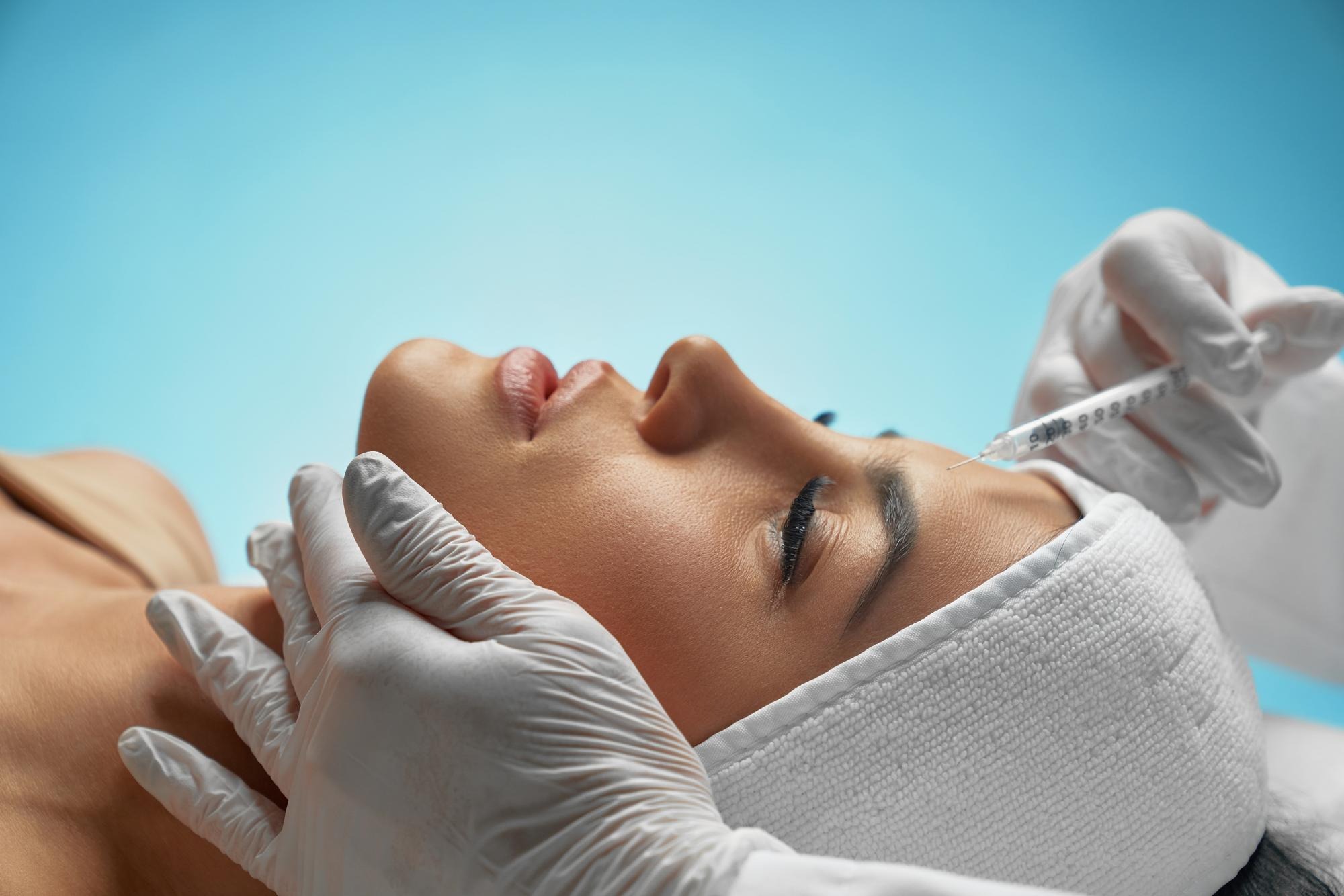 Cosmetic Botox injection into the female forehead