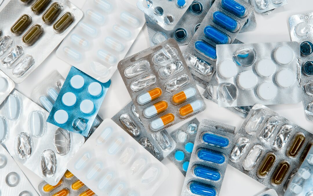 Colorful tablets and medicines on a white table