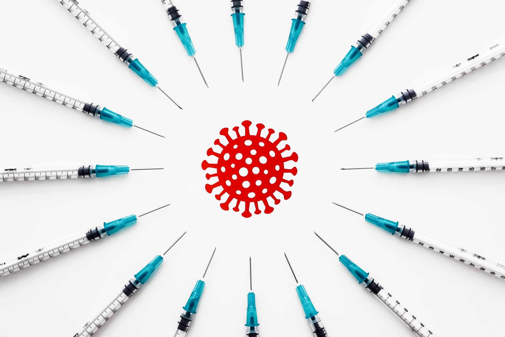 Injection syringe in a circle around a virus