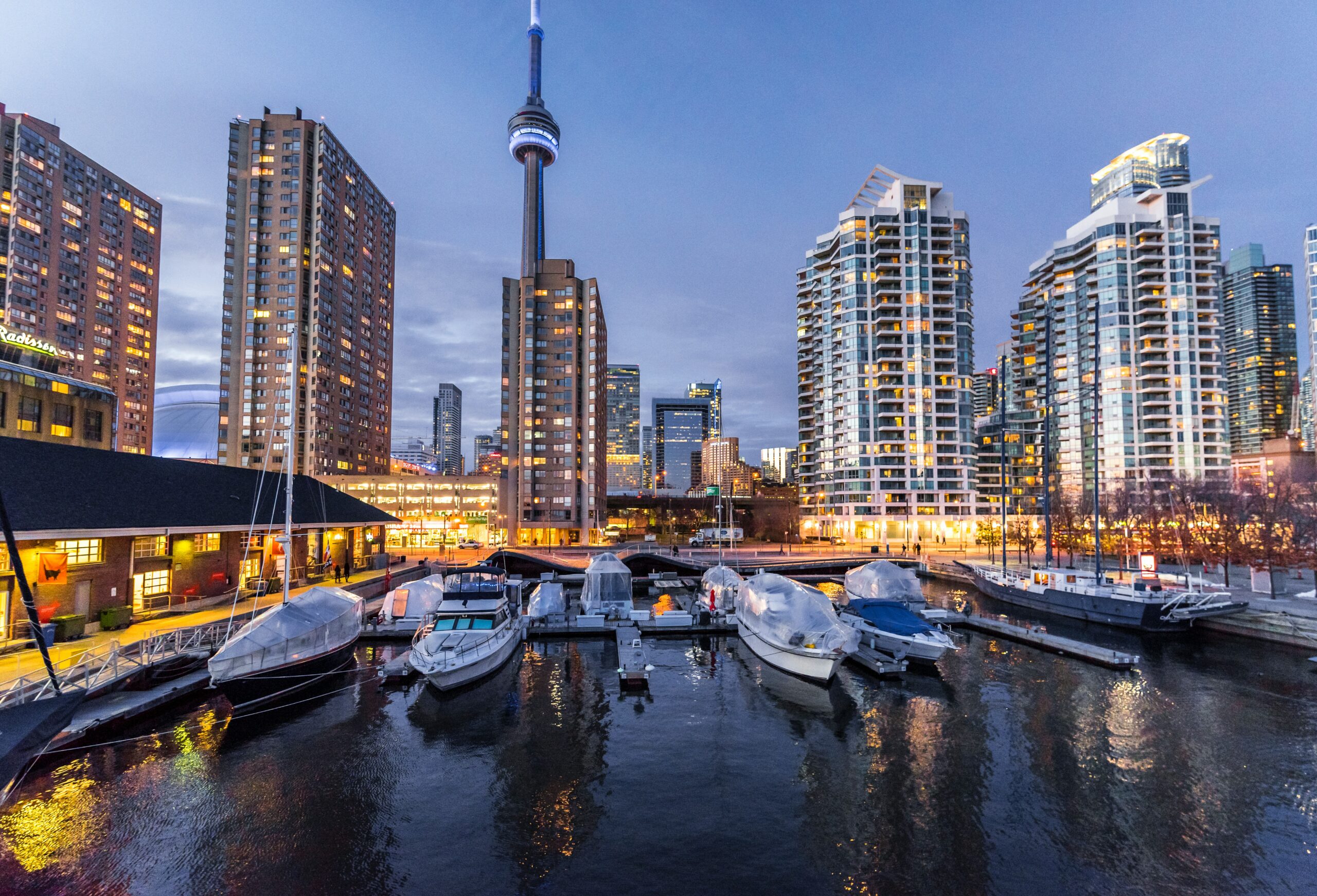 Canadian landscape with skyscrapers and a docks with boats