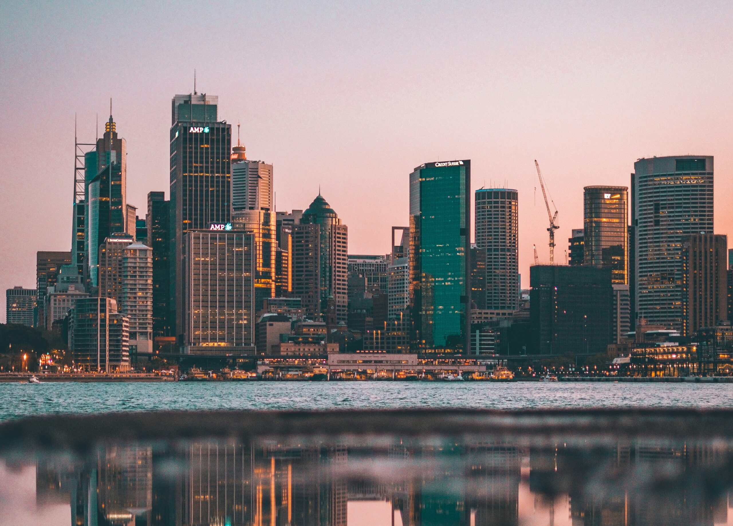 A picture of a skyline of a city at sunset.